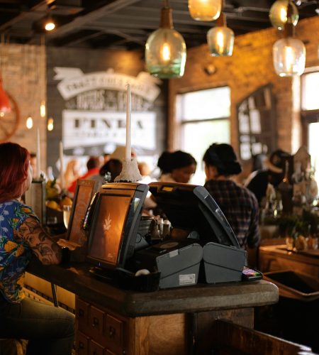 A bustling café in Miami with people enjoying a lively atmosphere and stylish interior design.best aesthetic cafe